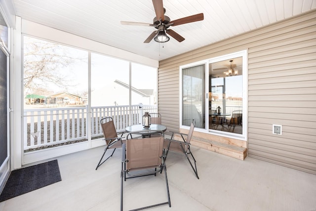 sunroom / solarium featuring a ceiling fan and a healthy amount of sunlight