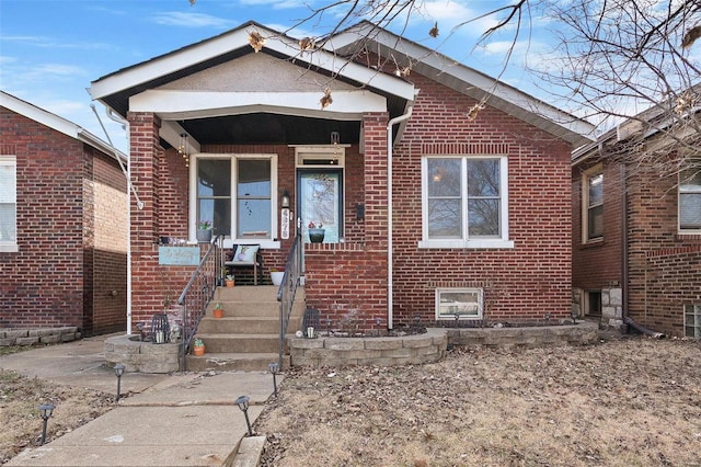 bungalow-style home with brick siding