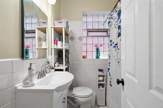 full bathroom featuring toilet, tile walls, and vanity