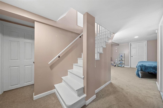 stairway featuring baseboards, carpet flooring, and recessed lighting