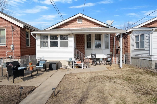 back of property with entry steps and fence