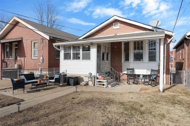 back of property featuring entry steps, a patio, fence, and an outdoor living space