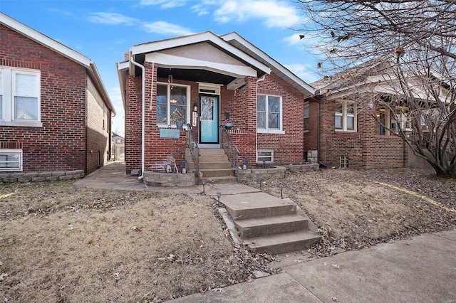 bungalow-style home featuring brick siding