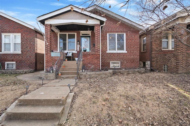 bungalow-style house with brick siding