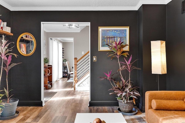 interior space with stairs, crown molding, wood finished floors, and visible vents