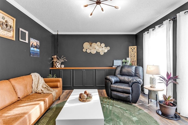 living area with a textured ceiling, crown molding, and wood finished floors