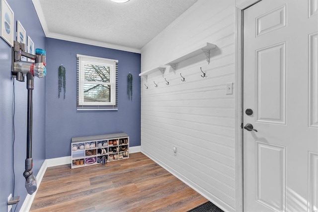 mudroom with wood finished floors, baseboards, and a textured ceiling