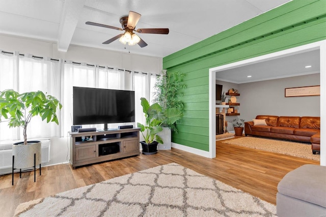 living area featuring a healthy amount of sunlight, ceiling fan, and wood finished floors