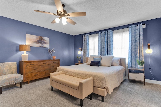 carpeted bedroom with a ceiling fan, baseboards, and a textured ceiling