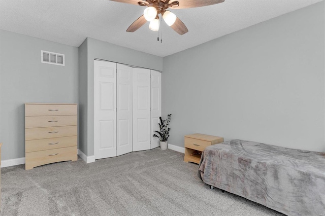 bedroom featuring visible vents, baseboards, carpet, and a closet