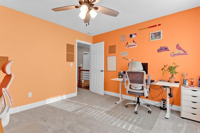 carpeted office featuring ceiling fan and baseboards