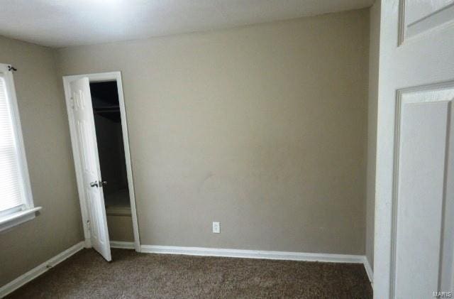 unfurnished bedroom with carpet floors and baseboards