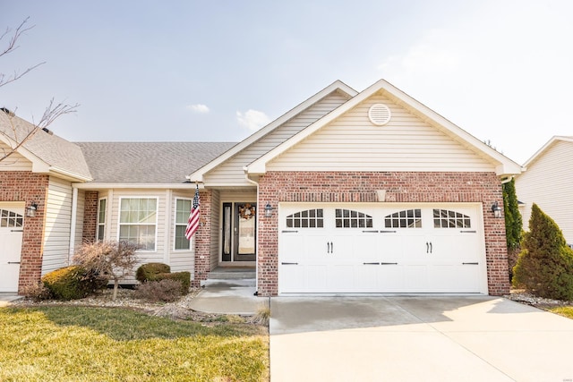 ranch-style house featuring a garage, brick siding, and driveway