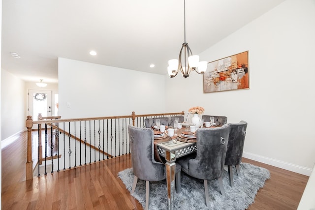 dining room with wood finished floors, baseboards, and a chandelier