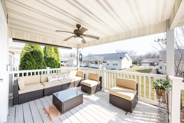 deck with a residential view, an outdoor living space, and a ceiling fan