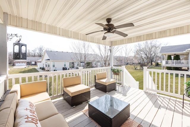 deck featuring a residential view, a lawn, ceiling fan, and outdoor lounge area