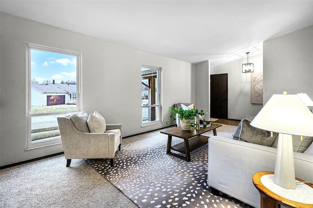 carpeted living room featuring a chandelier