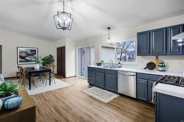 kitchen featuring light countertops, a sink, blue cabinetry, and stainless steel dishwasher