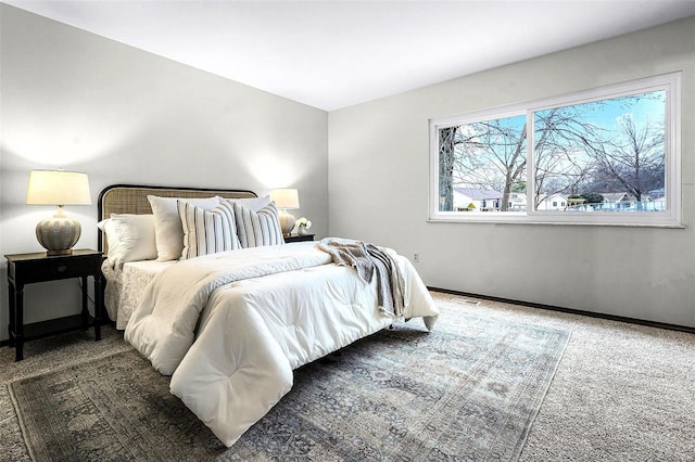 bedroom featuring carpet floors and baseboards