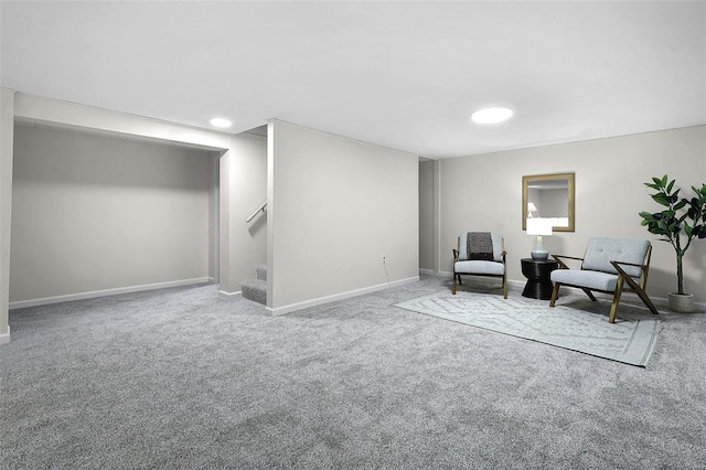 sitting room with carpet floors, stairway, and baseboards