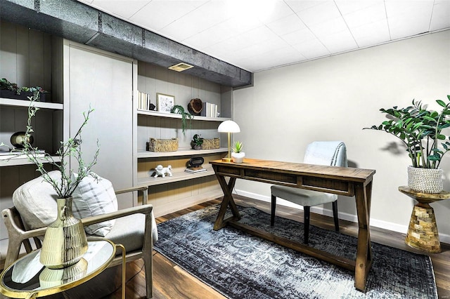 home office featuring visible vents, baseboards, and wood finished floors