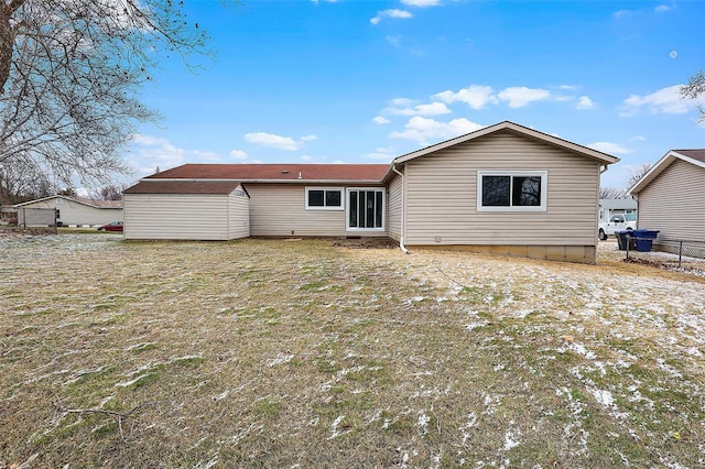 rear view of house featuring fence