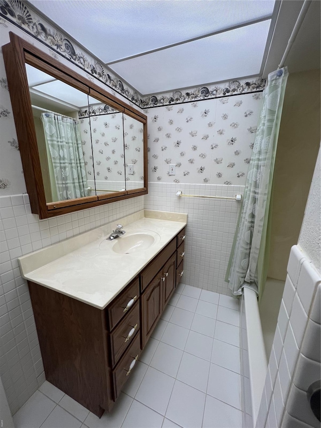 bathroom with tile walls, tile patterned flooring, vanity, and a shower with curtain
