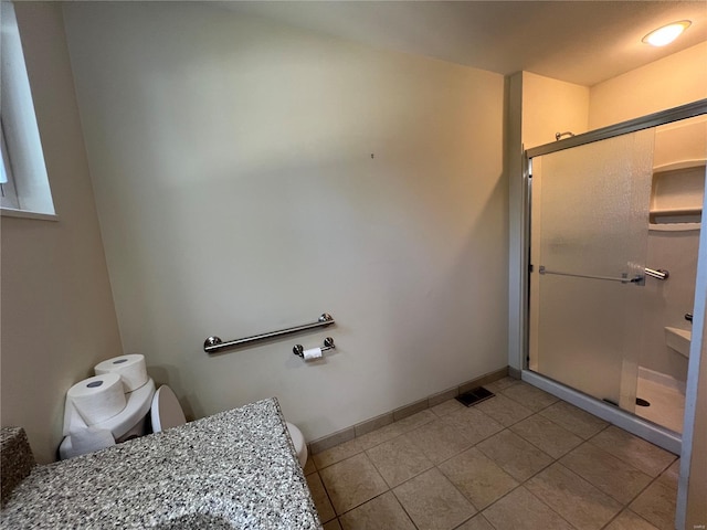 bathroom with tile patterned floors, visible vents, toilet, baseboards, and a stall shower