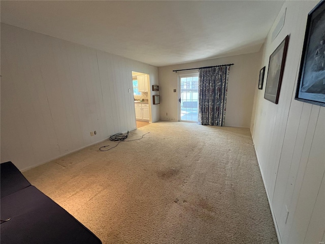 unfurnished room featuring light colored carpet