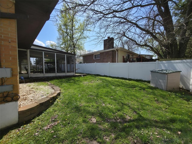 view of yard with a sunroom and fence