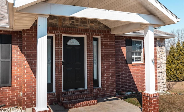 property entrance with brick siding