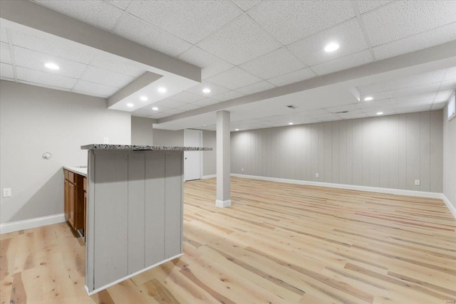 finished basement featuring recessed lighting, baseboards, and light wood-type flooring