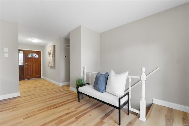 entryway featuring visible vents, baseboards, and light wood-style flooring