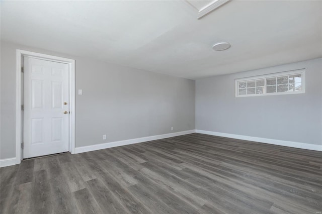 unfurnished room with baseboards and wood finished floors