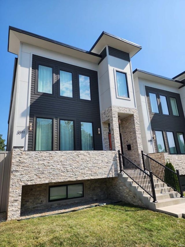 view of front of property featuring stone siding and a front yard