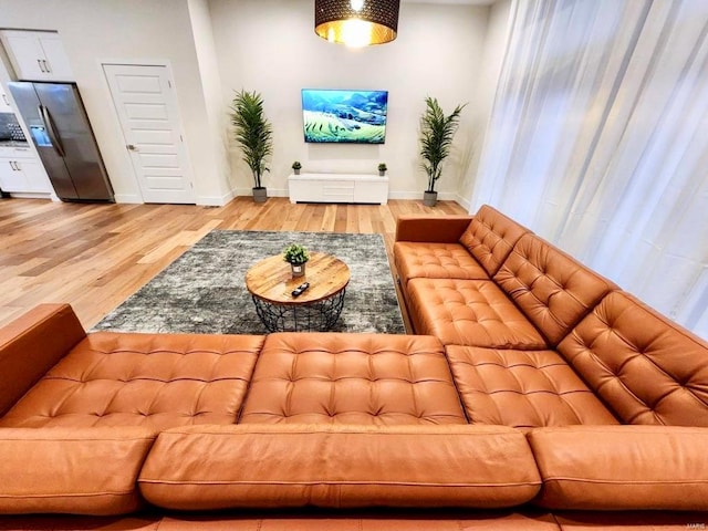 living room featuring light wood finished floors and baseboards