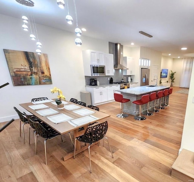 dining room featuring light wood finished floors and recessed lighting