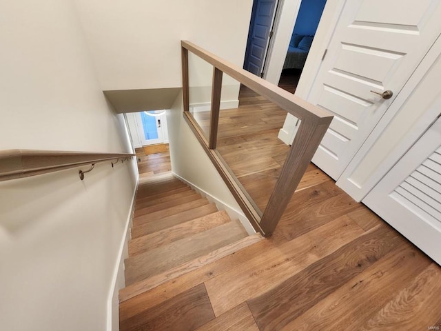 staircase with wood finished floors