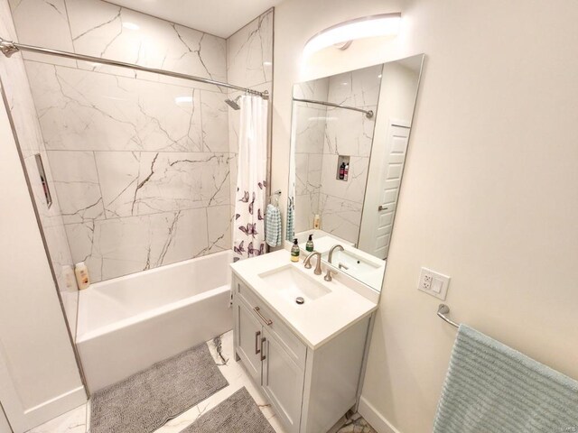 bathroom featuring baseboards, shower / bath combination with curtain, and vanity