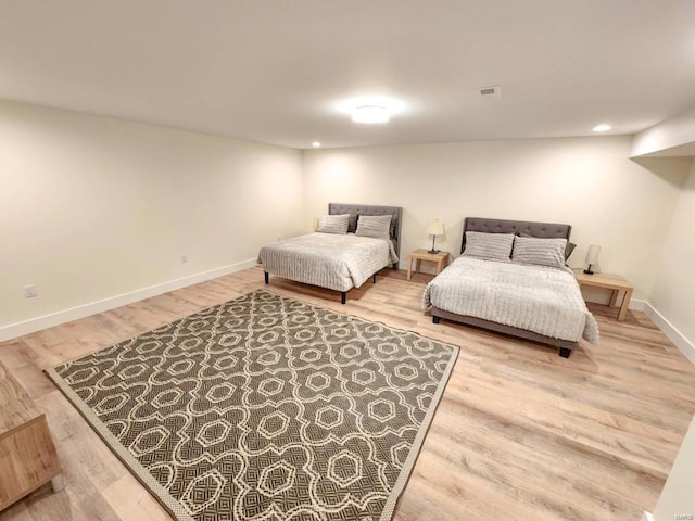 bedroom featuring recessed lighting, visible vents, baseboards, and wood finished floors