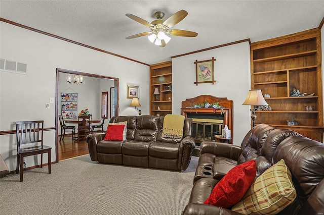 living area with built in features, crown molding, visible vents, and a textured ceiling