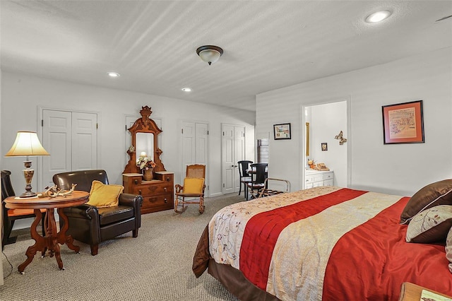 bedroom with a textured ceiling, multiple closets, carpet, and recessed lighting