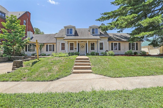 view of front of house featuring a chimney and a front yard