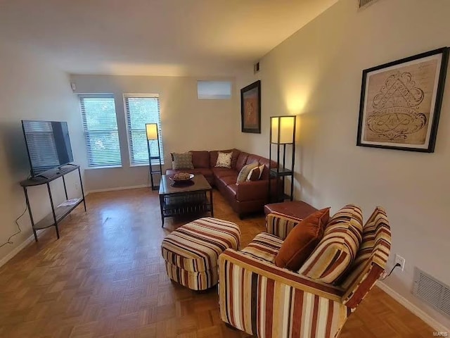 living room featuring visible vents and baseboards