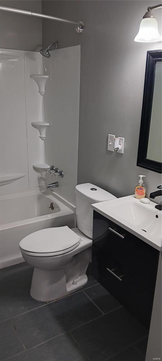 bathroom with  shower combination, tile patterned flooring, vanity, and toilet