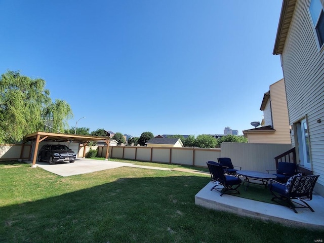 view of yard featuring a carport and fence