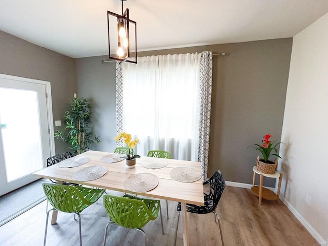 dining area featuring wood finished floors and baseboards