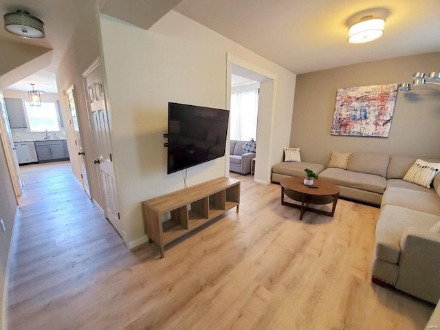 living room with light wood-style flooring and baseboards