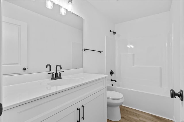 bathroom featuring toilet, shower / bath combination, wood finished floors, visible vents, and vanity