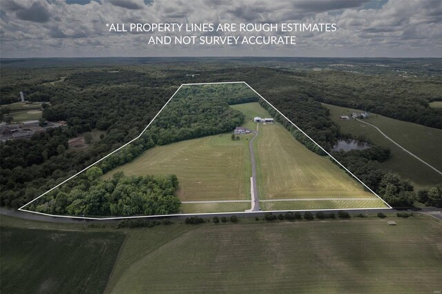 birds eye view of property featuring a rural view and a forest view